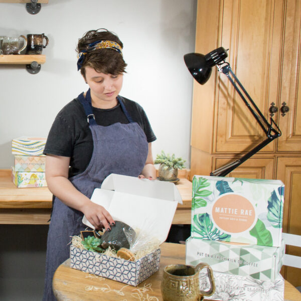 Contact us for help with your custom packaging boxes, team member assembling product box for Mattie Rae