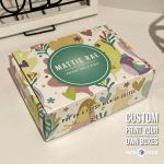 Whimsical custom printed box with colorful animal illustrations and a green Mattie Rae logo.